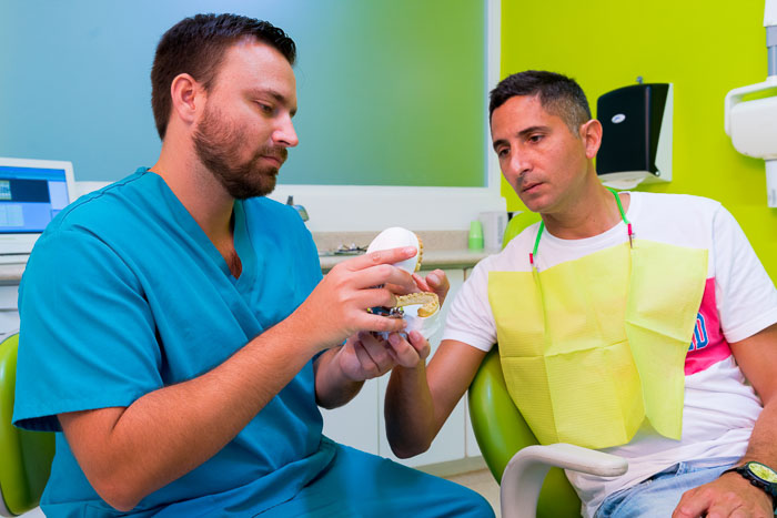 Patient and dentist talking after a dental crown procedure in Cancun.