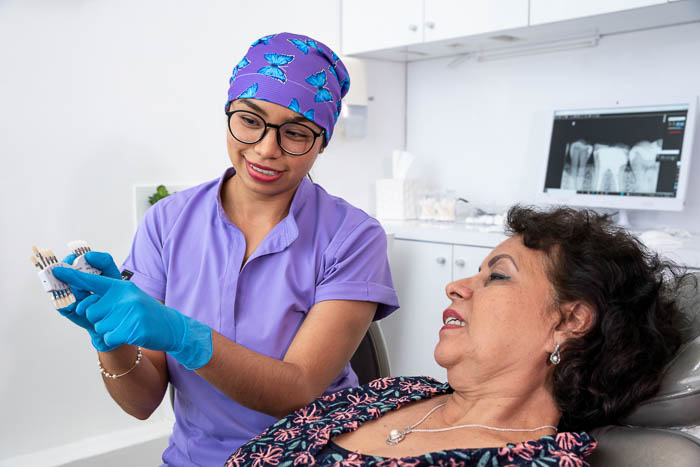 The dentist and the patient are talking about the snap on dentures procedure,