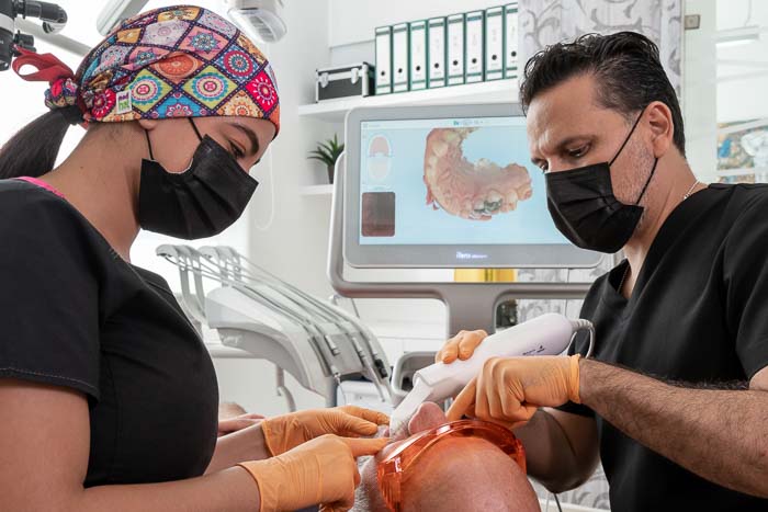 The doctors are performing a full mouth reconstruction procedure in Cancun.