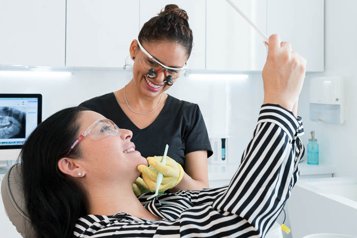 The patient and the doctor are smiling after the lumineer treatment in Cancun.