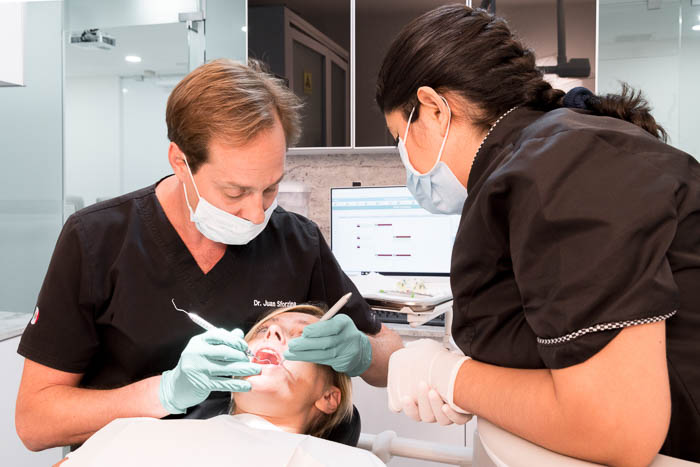 Doctors are performing a zygomatic implant consultation in Cancun.